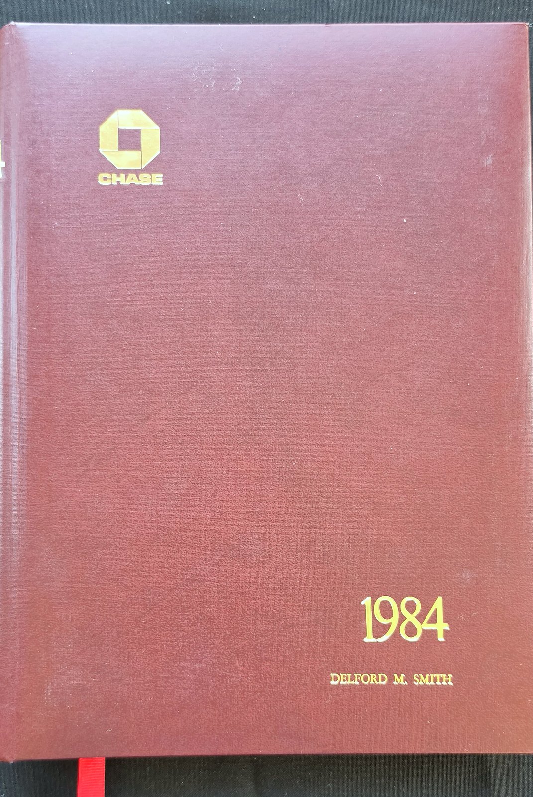 Burgundy cover of the 1984 Banker's Diary and Guide with the Chase logo, stamped in gold 1984 and Delford M. Smith
