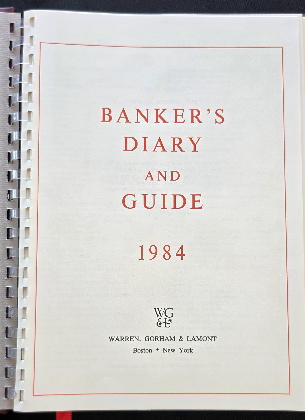 Title page reading Banker's Diary and Guide 1984, Warren, Gorham and Lamont, Boston, New York, beside the plastic spiral binding
