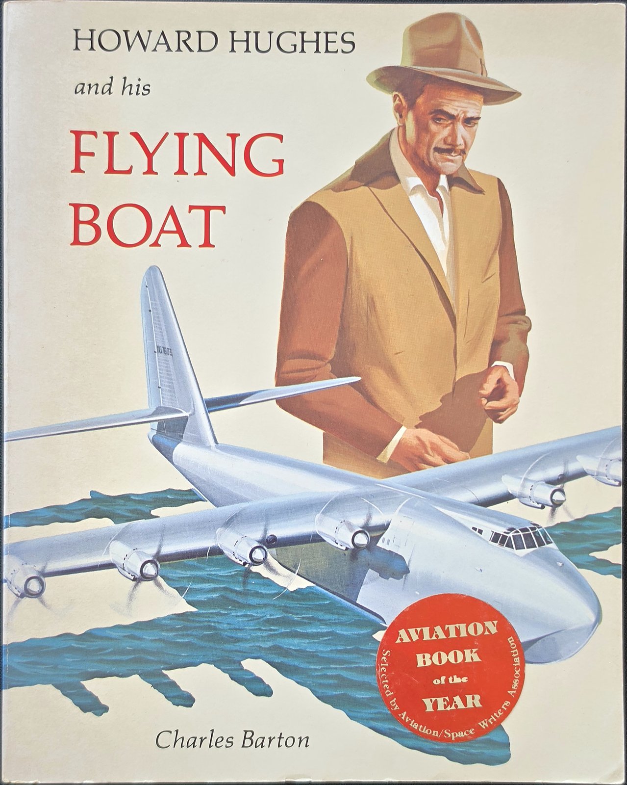 Cover of Howard Hughes and his Flying Boat by Charles Barton, with a painting of Howard Hughes in a fedora beside the flying boat, and a round Aviation Book of the Year sticker