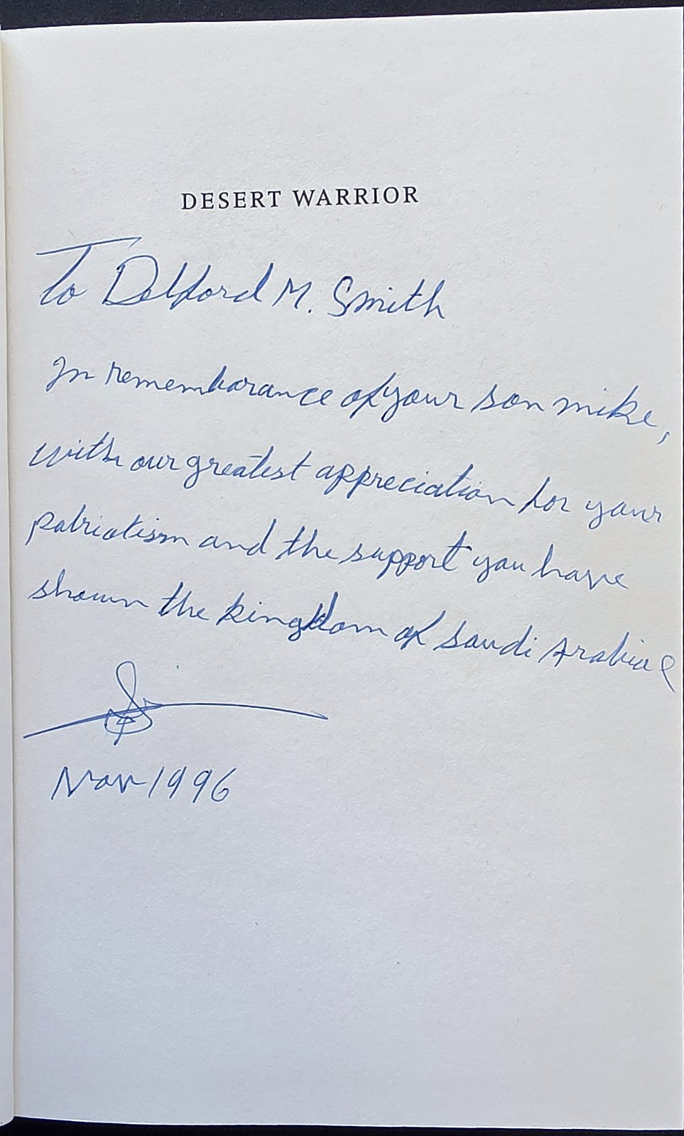 Title page of Desert Warrior with a handwritten inscription to Delford M. Smith in remembrance of his son Mike, dated Nov 1996
