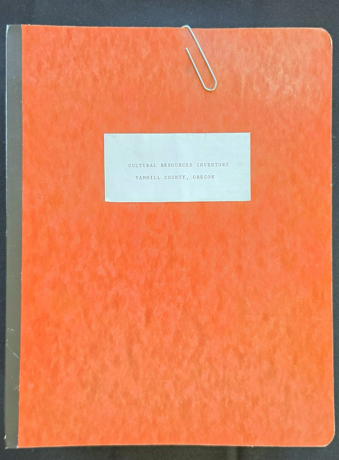 Orange pressboard folder with a paper clip and a typed label reading Cultural Resources Inventory, Yamhill County, Oregon
