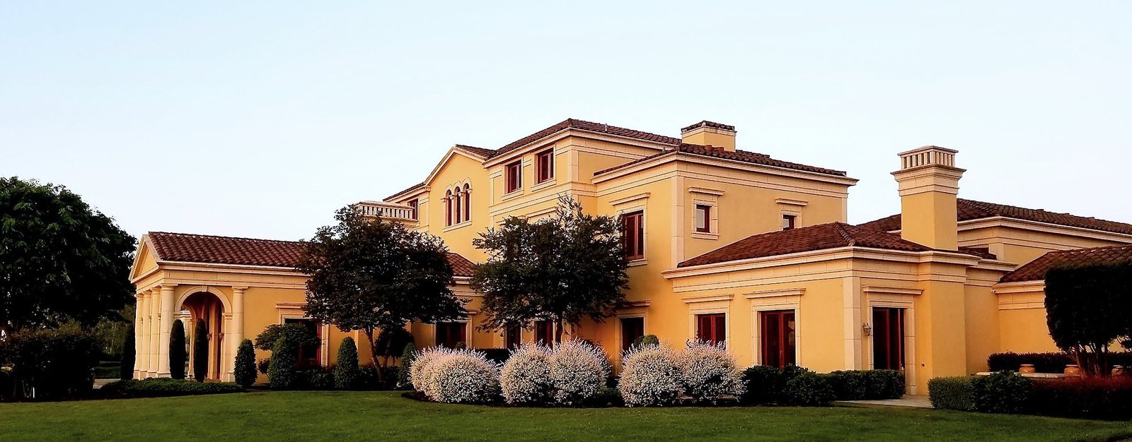 Del Mar Villa's front facade across the lawn